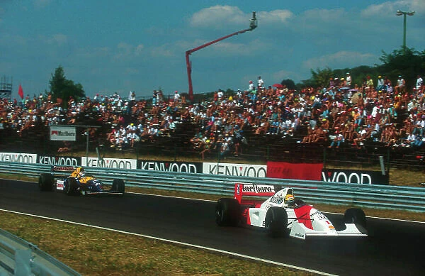 1992 Hungarian Grand Prix. Hungaroring, Hungary. 14-16 August 1992. Ayrton Senna (McLaren MP4 / 7A Honda) leads Nigel Mansell (Williams FW14B Renault). They finished in 1st