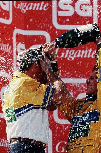 1993 Portuguese Grand Prix. Estoril, Portugal. 24-26 September 1993. Michael Schumacher (Benetton Ford) 1st position showers team boss Flavio Briatore on the podium. Ref-93 POR 03. World Copyright - LAT Photographic