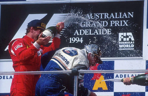 1994 Australian Grand Prix. Adelaide, Australia. 11-13 November 1994. Nigel Mansell (Williams Renault) 1st position gets sprayed with champagne on the podium. Gerhard Berger (Ferrari) 2nd position. Ref-94 AUS 09. World Copyright - LAT Photographic