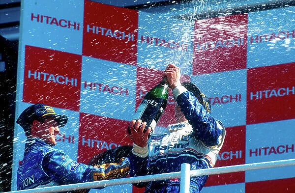 1994 British Grand Prix. Silverstone, England. 8-10 July 1994. Damon Hill (Williams Renault) 1st position gets showered by Michael Schumacher (Benetton Ford) 2nd position