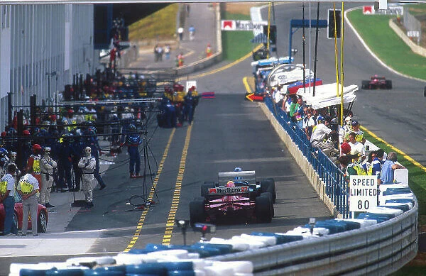 1994 European Grand Prix. Jerez, Spain. 14-16 October 1994. Jean Alesi (Ferrari 412T1B) follows a Ligier down the pit lane prior to his pitstop. Ref-94 EUR 14. World Copyright - LAT Photographic