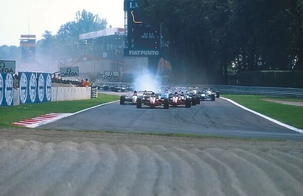 1994 Italian Grand Prix: Jean Alesi leads teammate Gerhard Berger with Johnny Herbert behind at the start