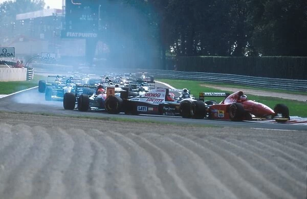 1994 Italian Grand Prix: Johnny Herbert is spun round at the Rettifilo Chicane at the start by Eddie Irvine because he could not brake as quickly