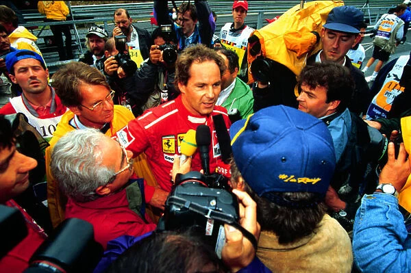 1995 BELGIAN GP. Gerhard Berger, Ferrari talks to the media after securing pole
