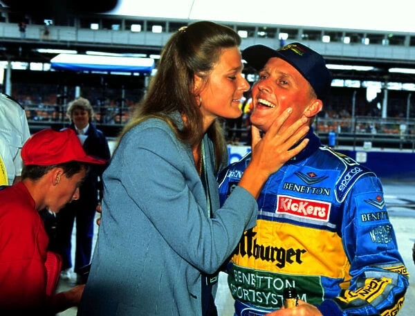 1995 BRITISH GP. Johnny Herbert celebrates with his wife after winning his home GP