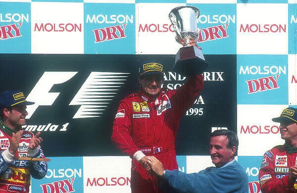 1995 Canadian Grand Prix. Montreal, Quebec, Canada. 9-11 June 1995. Jean Alesi (Ferrari 412T2) celebrates 1st position for his maiden Grand Prix win on the podium
