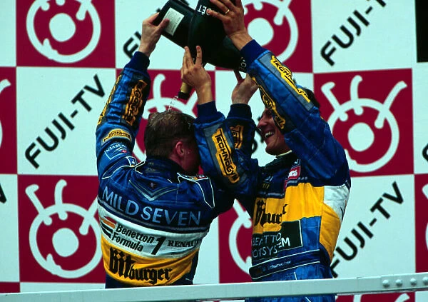 1995 JAPANESE GP. Michael Schumacher and Johnny Herbert celebrate in Suzuka after