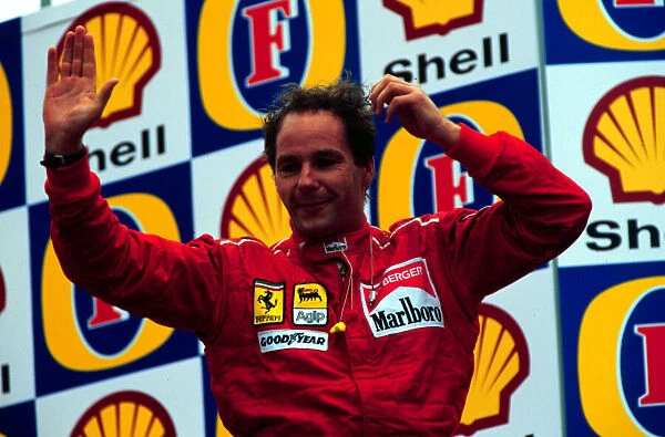 1995 SAN MARINO GP. Gerhard Berger celebrates on the podium after coming 3rd at Imola