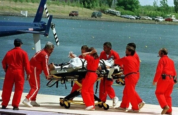 1997 CANADIAN GP. Prost driver Olivier Panis is taken away on a stretcher after