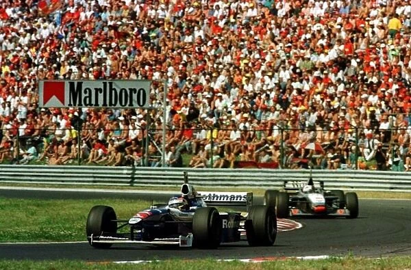 1997 GERMAN GP. Race winner Jacques Villeneuve leads David Coulthard. Photo: LAT