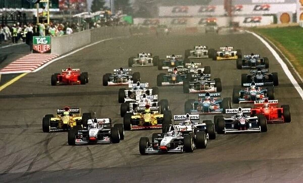 1997 LUXEMBOURG GP. Mika Hakkinen leads away the field at the start of the race