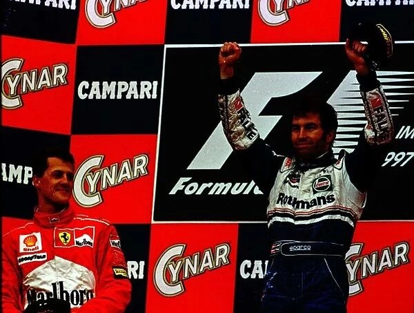 1997 SAN MARINO GP. Heinz-Harald Frentzen celebrates on the podium for the first