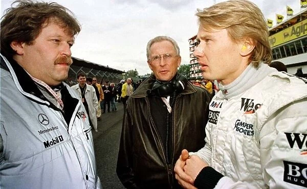 1997 SAN MARINO GP. Mika Hakkinen chats with Norbert Haug and Dr Werner Hubert