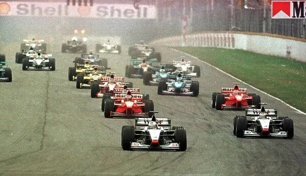 1998 ARGENTINIAN GP. Mercedes team mates, David Coulthard and Mika Hakkinen lead the field into the first corner of the race in Buenos Aires. Photo: LAT
