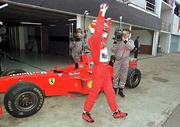 1998 ARGENTINIAN GP. Micheal Schumacher, Ferrari, celebrates in Parc Ferm after winning the race in Buenos Aires. Photo: LAT