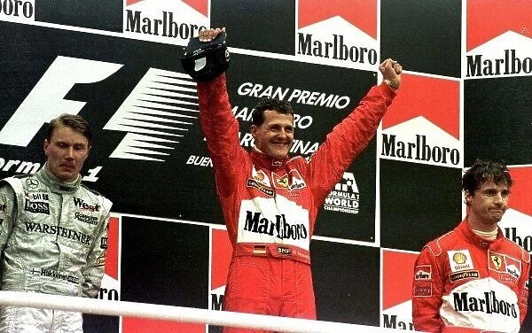 1998 ARGENTINIAN GP. Micheal Schumacher, Ferrari, raises his arms in victory after winning the race in Buenos Aires. Photo: LAT