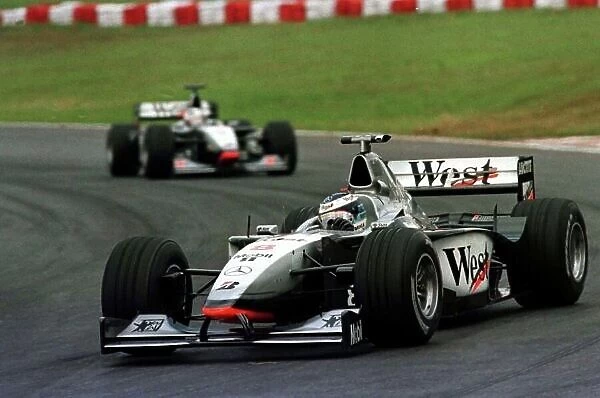 1998 BRAZILIAN GP. Mika Hakkinen, McLaren Mercedes, leads his team mate David Coulthard to win the race in Sao Paulo. Photo: LAT