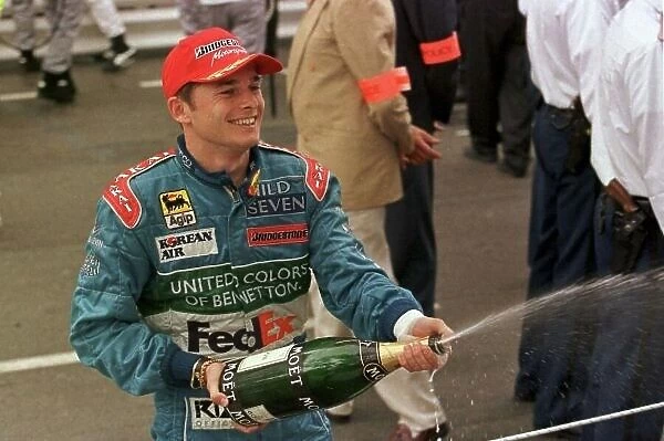 1998 MONACO GP. Giancarlo Fisichella, Benetton, sprays the celebration champagne after finishing 2nd in Mont Carlo behind Mika Hakkinen. Photo: LAT