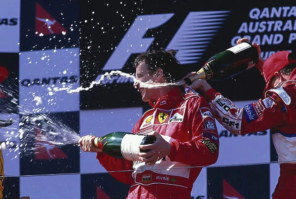 1999 Australian Grand Prix. Melbourne, Australia. 5-7 March 1999. Eddie Irvine (Ferrari) celebrates his maiden Grand Prix win with Ralf Schumacher (Williams Supertec) 3rd position on the podium. Ref-99 AUS 50. World Copyright - LAT Photographic