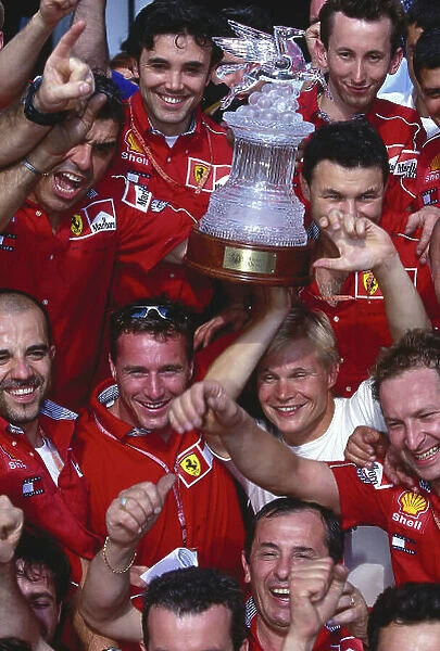 1999 German Grand Prix. Hockenheim, Germany. 30 / 7-1 / 8 1999. Eddie Irvine (Ferrari) 1st position celebrates with team mate Mika Salo, 2nd position and the rest of the team. Ref-99 GER 76. World Copyright - LAT Photographic
