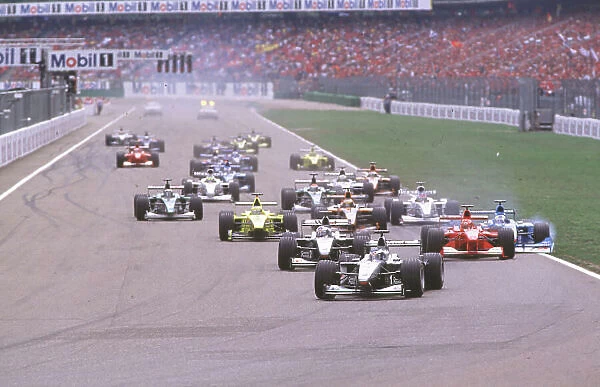 2000 German Grand Prix Hockenheim, Germany, 28th - 30th July 2000. Michael Schumacher, Ferrari and Giancarlo Fisichella collide at the start of the race. World Coates  /  LAT ref: 35 mm race action