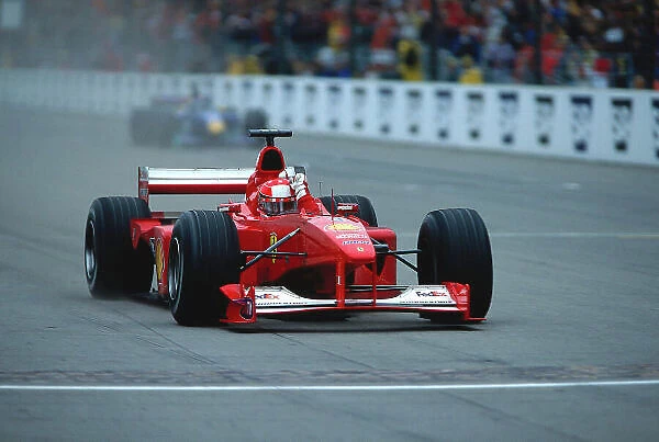 2000 United States Grand Prix. Indianapolis, Indiana, USA. 22-24 September 2000. Michael Schumacher (Ferrari F1-2000) celebrates his 1st position as he crosses the finish line. Ref-2K USA 21. World Copyright - LAT Photographic