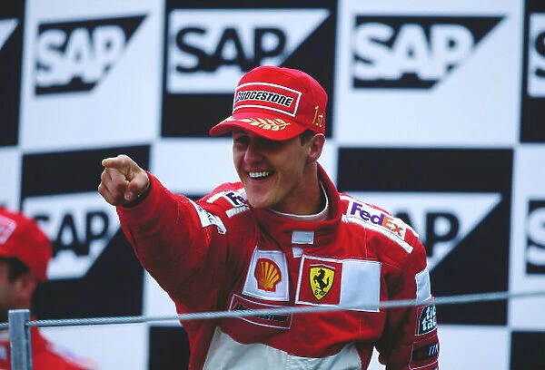 2000 United States Grand Prix. Indianapolis, Indiana, USA. 22-24 September 2000. Michael Schumacher (Ferrari) celebrates his 1st position on the podium. Ref-2K USA 40. World Copyright - LAT Photographic