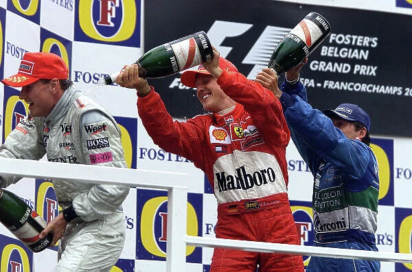 2001 Belgian Grand Prix - Race Spa Francorchamps, Belgium. 2nd Spetember 2001. Race podium. Michael Schumacher, Ferrari F2001 1st, David Coulthard, West McLaren Mercedes MP4 / 16 2nd and Giancarlo Fisichella