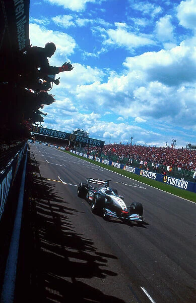 2001 British Grand Prix. Silverstone, England. 13-15 July 2001. The team celebrates as Mika Hakkinen (McLaren MP4 / 16 Mercedes) takes 1st position. Ref- 35mm Image 01 GB 19. World Copyright - LAT Photographic