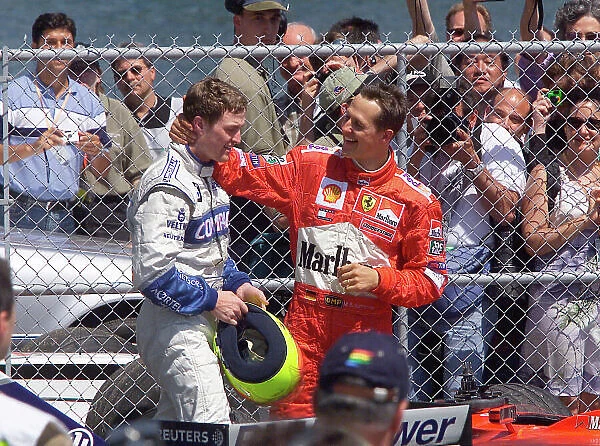 2001 Canadian Grand Prix - Race Montreal, Canada. 10th June 2001. Michael Schumacher, Ferrari F2001, congratulates race winner and brother Ralf Schumacher