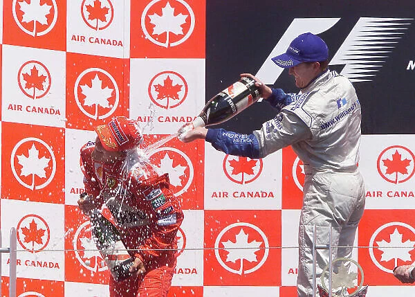 2001 Canadian Grand Prix - Race Montreal, Canada. 10th June 2001. Podium - Ralf Schumacher, BMW Williams FW23 (1st), brother Michael Schumacher, Ferrari F2001 (2nd) celebrate. World Copyright: Steve Etherington / LAT Photographic. ref