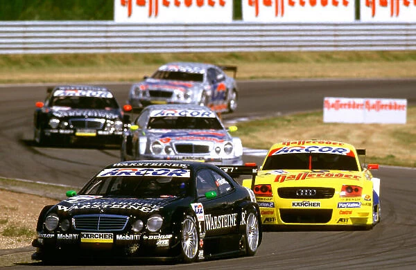 2001 DTM Championship Oscersleben, Germany. 19th - 20th May 2001. At the start of the race, Marcel Fassler, (AMG Mercedes-Benz CLK), leads the Audi of Laurent Aiello and Bernd Schneider - action