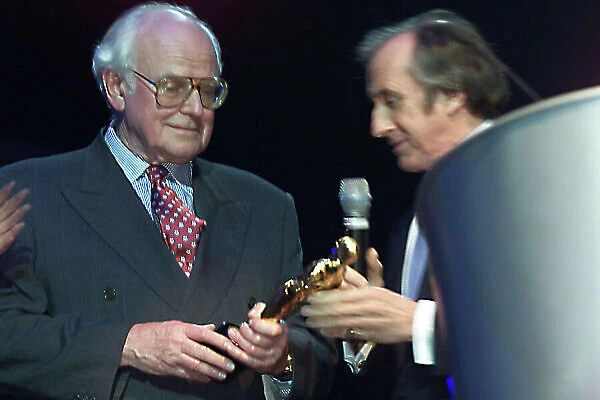 2001 Grand Prix Party. Royal Albert Hall, London, England. 12th February 2001. Sid Watkins recieves a Bernie award from Jackie Stewart World Copyright: Malcolm Griffiths / LAT Photographic. Ref: Digital Image 265G3700