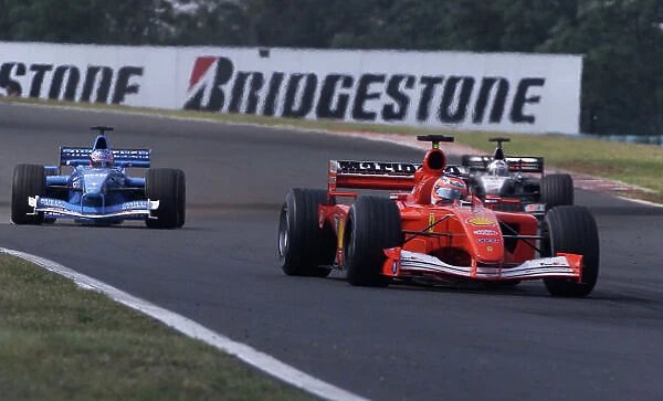2001 Hungarian Grand Prix - Race. Hungaroring, Hungary. 19th August 2001. Rubens Barrichello, Ferrari F2001, leads David Coulthard, West McLaren Mercedes MP4 / 16