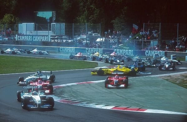 2001 Italian Grand Prix: Poleman Juan-Pablo Montoya leads Rubens Barrichello and Ralf Schumacher as Michael Schumacher takes to the inside of
