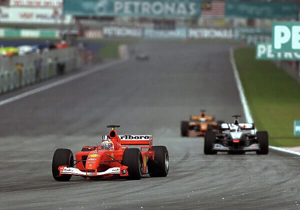 2001 Malaysian Grand Prix- Race. Sepang, Kuala Lumpur, Malaysia. 16th - 18th March 2001. Rubens Barrichello, Ferrari leads David Coulthard, McLaren Mercedes and Jos Verstappen