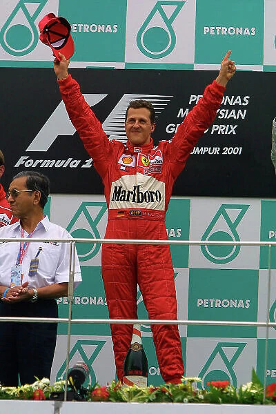 2001 Malaysian Grand Prix - Race Sepang, Kuala Lumpur, Malaysia. 16th - 18th March 2001. Michael Schumacher, Ferrari makes it 6 wins in a row. Podium Celebration World Copyright: Steve Etherington  /  LAT Photographic. ref: 9mb Digital Image
