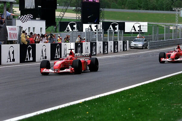2002 Austrian Grand Prix A1-Ring, Austria, 10th-12th May 2002 Michael Schumacher, Ferrari F2002, follows team orders and takes over team mate Rubens Barrichello, Ferrari F2002. World Copyright Photo4