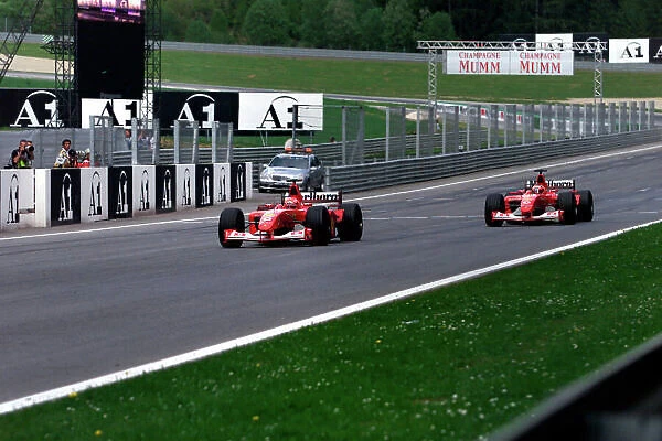2002 Austrian Grand Prix A1-Ring, Austria, 10th-12th May 2002 Michael Schumacher, Ferrari F2002, follows team orders and takes over team mate Rubens Barrichello, Ferrari F2002. World Copyright Photo4