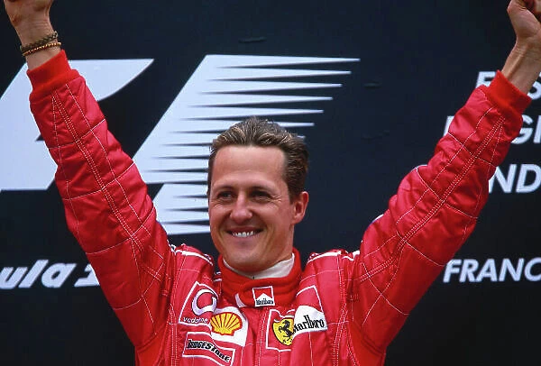 2002 Belgian Grand Prix. Spa-Francorchamps, Belgium. 30 / 8-1 / 9 2002. Michael Schumacher (Ferrari) celebrates his 1st position and record 10th Grand Prix win in a single season, on the podium. Ref-02 BEL 23. World Copyright - Rose / LAT Photographic