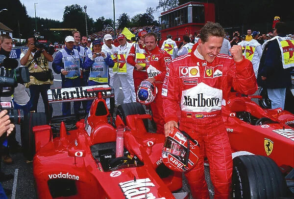 2002 Belgian Grand Prix. Spa-Francorchamps, Belgium. 30 / 8-1 / 9 2002. Michael Schumacher (Ferrari) celebrates his 1st position and record 10th Grand Prix win in a single season in parc ferme. Rubens Barrichello (Ferrari) 2nd position stands behind