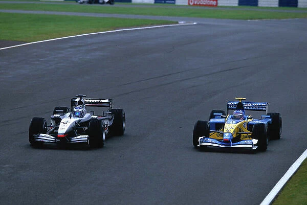 2002 British Grand Prix, Silverstone, England. 7th July 2002. Kimi Raikkonen passes Jenson Button on the way down to Bridge in the contest between the Michelin runners. World Copyright - LAT Photographic Ref: 35mm Original A22