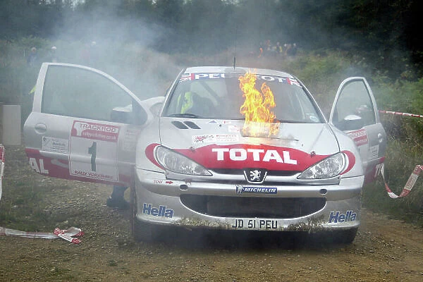 2002 British Rally Championshio Trackrod Rally, England. 28th - 29th September 2002. Justin Dale / Andrew Bargery's Peugeot 206 catches fire, forcingthem to retire from the rally. World copyright: Jacob Ebrey / LAT Photographic ref: Digital Image Only