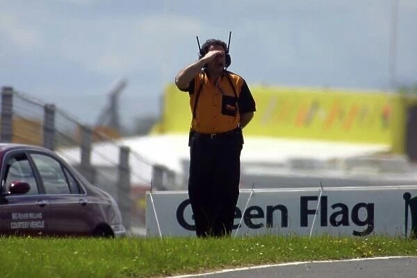 2002 British Touring Car Championship Mondello Park, Ireland. 22nd-23rd June 2002 Vic Lee, Team Halfords boss, looks at the track conditons after Paul O'Neill's engine coated the track in oil. Photo