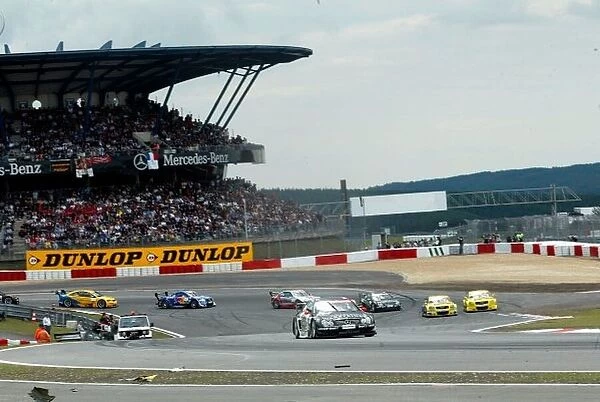 2002 DTM Championship Hurburgring, Germany. 4th August 2002 Uwe Alzen (Merecedes-Benz CLK-DTM) leads the Abt-Audi TT-Rs of Laurent Aiello and Christian Abt - as they pass the accident rermains of Jean Alesi and Alain Menu