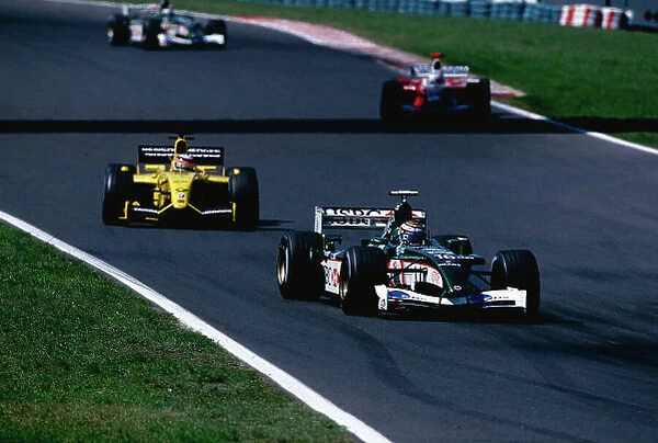 2002 Hungarian Grand Prix. Hungaroring, Hungary. 16-18 August 2002. Eddie Irvine (Jaguar R3) followed by Takuma Sato (Jordan EJ12 Honda). Ref-02 HUN 28. World Copyright - Coates / LAT Photographic