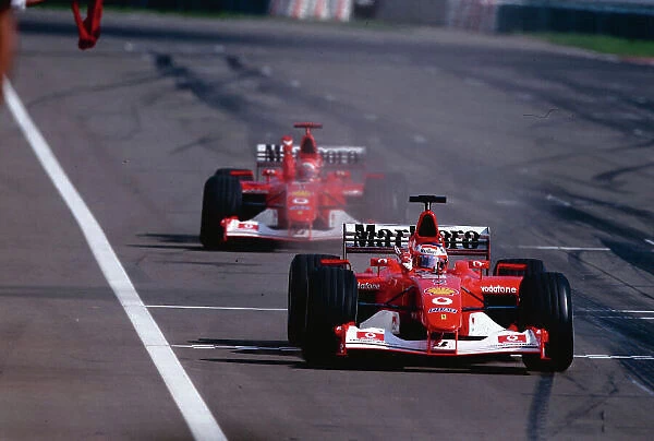 2002 Hungarian Grand Prix. Hungaroring, Hungary. 16-18 August 2002. Rubens Barrichello closely followed by team mate Michael Schumacher (both Ferrari F2002's)