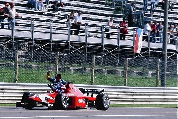 2002 International F3000 Monza, Italy. 14th September 2002 3rd position secured the championship title for Tomas Enge (Arden), and he gives a lift back to the pits to his closest rival Sebastien Bourdais (Super Nova). World Copyright