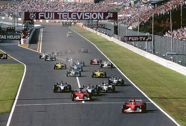2002 Japanese Grand Prix Suzuka, Japan. 11th - 13th October 2002. Race winner Michael Schumacher, Ferrari F2002, leads team mate Rubens Barrichello, at the start of the race