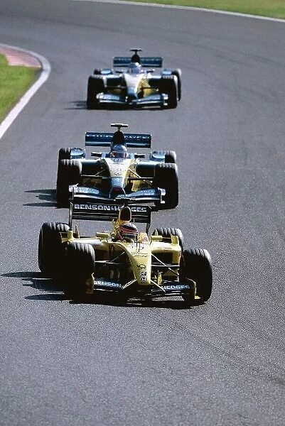 2002 Japanese Grand Prix Suzuka, Japan. 11th - 13th October 2002. Takuma Sato, Jordan Honda EJ12, leads Jarno Trulli, Renault R202, and Jenson Button, action